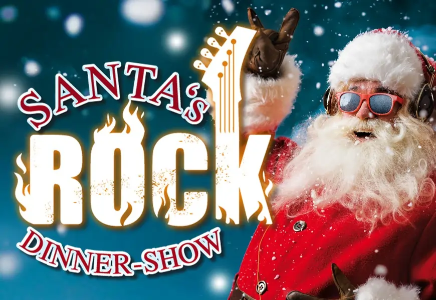Santas Rock Dinnershow 2025. Weihnachtsmann mit Sonnenbrille zeigt Peace zeichen.